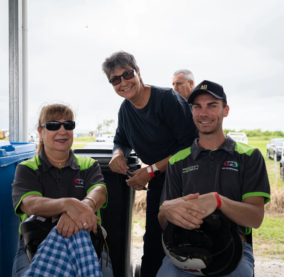 Race-day guests in the pit area with their helmets