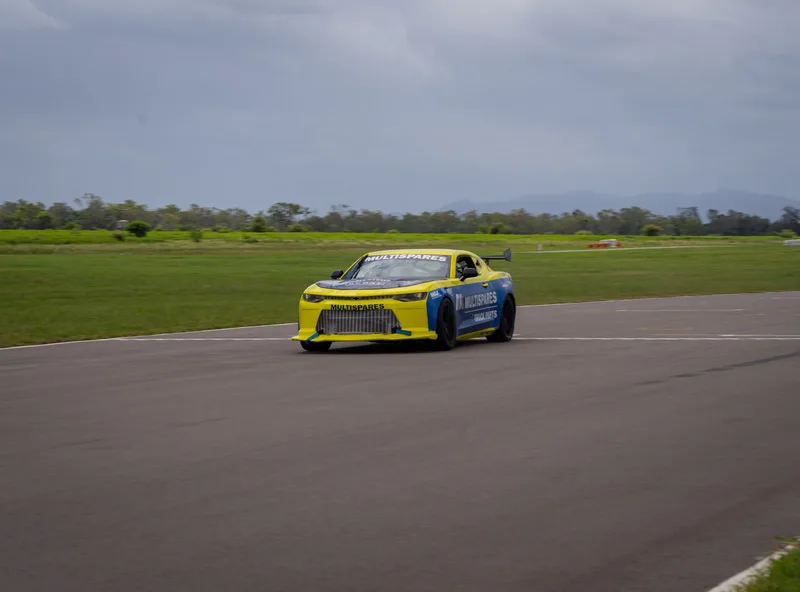 Yellow and blue Multispares race car on track